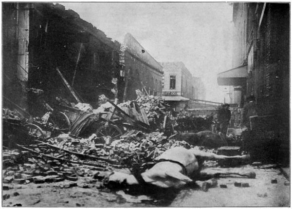 A Photograph of the Devastation in the Wholesale District. A Horse Lies Dead in the Middle of the Street, Surrounded by Rubble