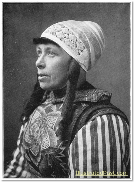 A woman from Marken Island, North Holland, wearing traditional costume. The elaborate breast plate is called "construction".
