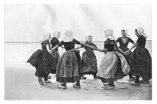 Dutch Girls Doing Traditional Dutch Dance by the Seashore