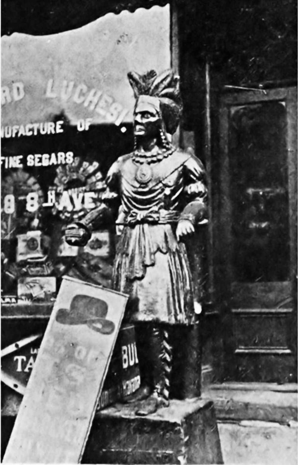 Elaborately Carved Cigar Store Indian Stands In Front of a Shop Window Advertising Fine "Segars".
